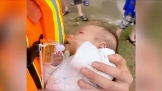 Firefighter turns into a babysitter during flood relief operation