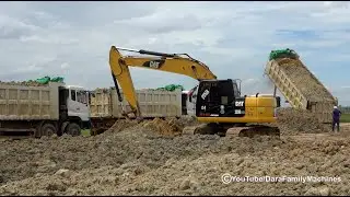 Dump truck and excavator working - dump trucks unloading soil