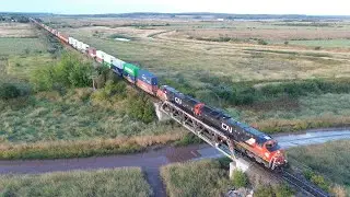 Awesome Aerial 4K View! Long Extra Stack Train CN X121 passing Nappan, NS at Track Speed
