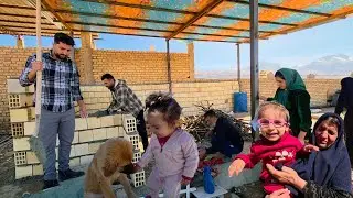 Rural family &ndash; Ava and Roz playing at the same time as the family works in the cowshed of Peren
