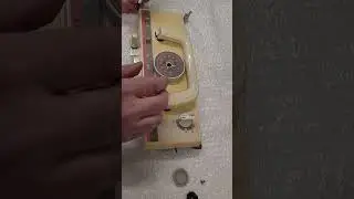 Removing the handle and stitch cam from a brother knitting machine carriage.