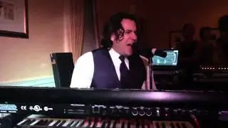Groom plays and sings a song he wrote for his bride.