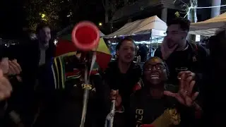 South African fans dance in the rain as they celebrate Rugby World Cup win