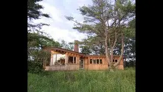 IRREGULAR SHAPED WOODEN HOUSE DESIGN WITH SHALLOW PITCH AND FLAT ROOFS