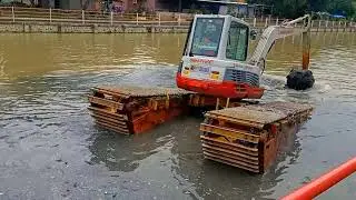 Construction equipment bulldozer excavator working to build a new river