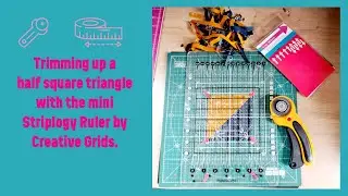 Trimming up half square triangles with the Creative Grids mini Stripology Ruler.