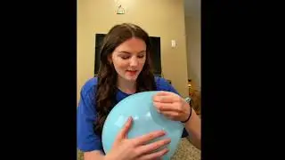 Cute Girl bursts different balloons with a needle