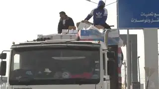 Trucks carrying humanitarian aid, including fuel, drive through Rafah crossing with Egypt into Gaza