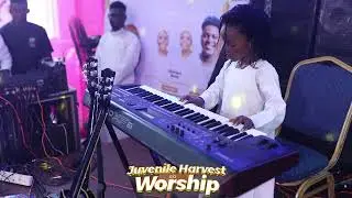 Little Boy playing keyboard at Juvenile Harvest worship with Bola Halleluyah  2.0