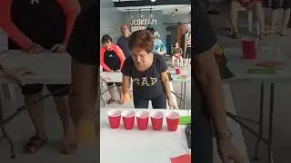 Senior Playing Ping Pong Ball in the Cup Games