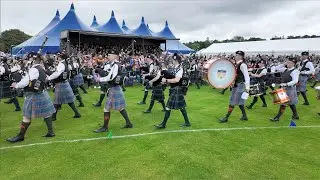 Pipe Bands lead the opening parade of 2024 Inverness Highland Games with Clan Societies in Scotland