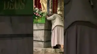 Touching the statue to the footprint of Saint Michael at the Holy Cave of Gargano