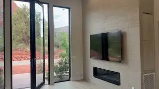 Fireplace Wall panel, Wood floor , 100&rdquo; wide Ceiling fan, 12 ft high pivot iron door compliments 