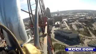 Tower climbers work high above downtown
