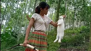 Primitive life - The hunter girl caught a rabbit in a wild forest