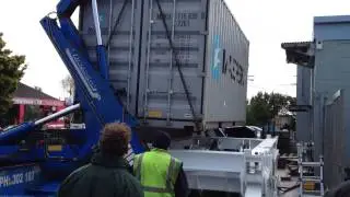 Steelbro Swing Lift Trailer Swinging a 20ft Shipping Container Onto an A-Ward Container Tilter