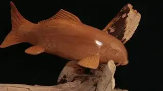 Carving a Koi out of a block of wood.
