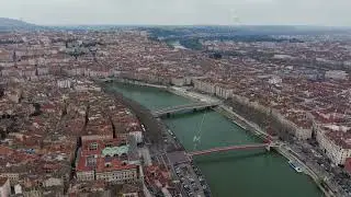Scenic aerial panorama revealing Lyon's urban landscape, showcasing Saone river flowing beneath