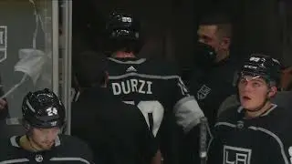 Sean Durzi leaves the game after taking a puck to the face.