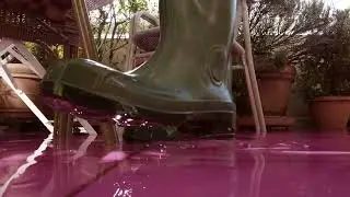 Boot Stepping in Pink Liquid &ndash; Creative Close-Up Shot in Natural Sunlight | 4K Stock Footage
