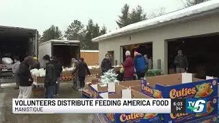Volunteers distribute food from Feeding America truck in Manistique