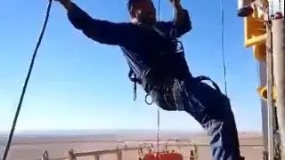 Man Riding Winch On Rig Carrier