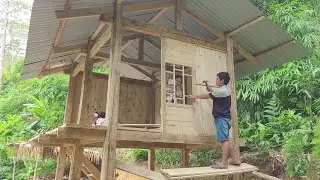 The couple worked together to build the house walls using wooden planks and design the doors.