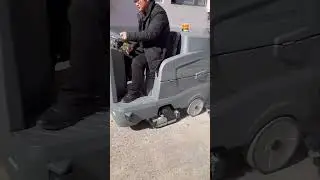 Ride-on floor scrubber sweeping and washing in onePebbles, particles, and debris are taken away