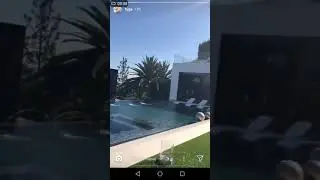 Tyga's chillin' at his mansion with his song on background
