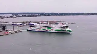 Aerial footage of large cruise ferry boat leaving port and transporting passengers and vehicles to