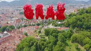 Inscription on video. Graz, Austria. Clock Tower in Graz. The historic city center aerial view. Moun