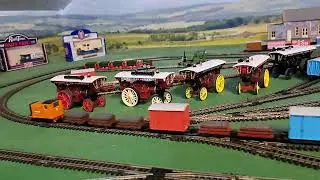 Bachmann Rusty pulling 3 brown 2 red slate wagons, red box van and blue brakvan 
