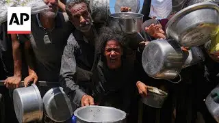 Hungry Palestinians crowd around a soup kitchen in Khan Younis for food