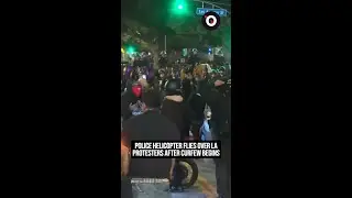 Police helicopter flies over LA protester after curfew begins