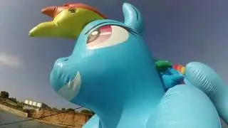 Pouncing inflatable Rainbow Dash pony in water