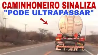 Caminhoneiro sinaliza para motorista ultrapassar na rodovia 