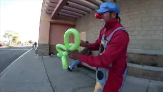 Clown makes a balloon elephant for the public