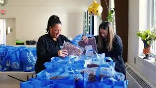 Behind The Seams Fashion Show Committee Volunteers to Pack and Distribute Food Bags