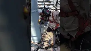 Sparks fly as welders shape steel cylinder