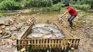 Masterful fishing skills. The boy made his own bamboo fish trap to catch fish in the stream.