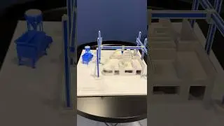 The video shows a model of a 3D construction printer with six support columns