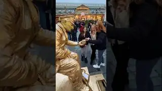 The Naughty Goldman seating on nothing offering prank business cards.😂 #prank #livingstatue