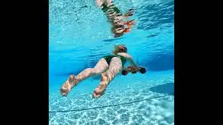 The little girl is diving by using MANTA sea scooter.