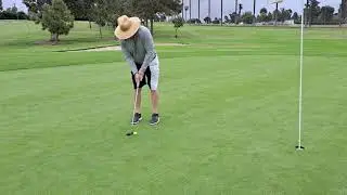 Golfer attempts short first hole birdie putt on shaggy poa annua greens