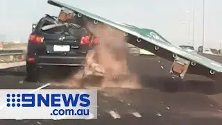 Shocking moment freeway sign CRUSHES car | Nine News Australia