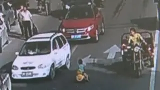 Boy rides toy car into rush hour traffic