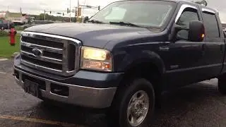 2005 Blue F250 XLT Crew Cab 4dr 4x4 Power stroke 6.0 Turbo Diesel V8 with a roll bar