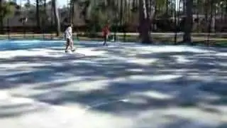 Spraying Novacrylic Ultracushion on a new Tennis Court
