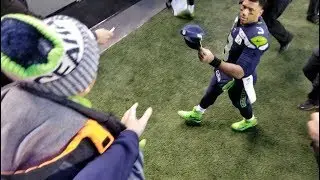 Russell Wilson giving gear to kids - Arizona Game