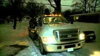 Tow Truck Drivers Working Overtime Pulling Cars Out Of Ditches